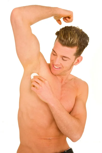 Genç erkek deodorant uygulamak — Stok fotoğraf