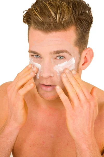 Young man applying lotion on her face — Stock Photo, Image