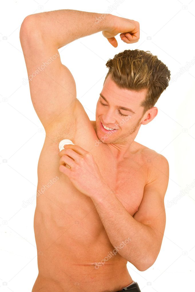 Young man applying deodorant