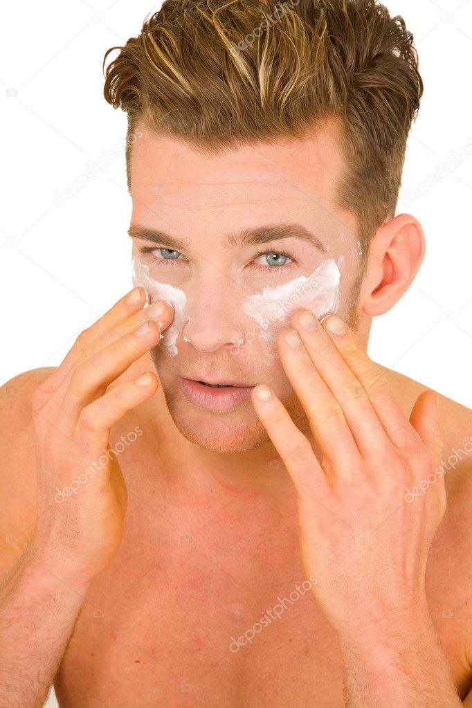 Young man applying lotion on her face