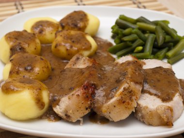 Roast pork in gravy with Silesian dumplings clipart