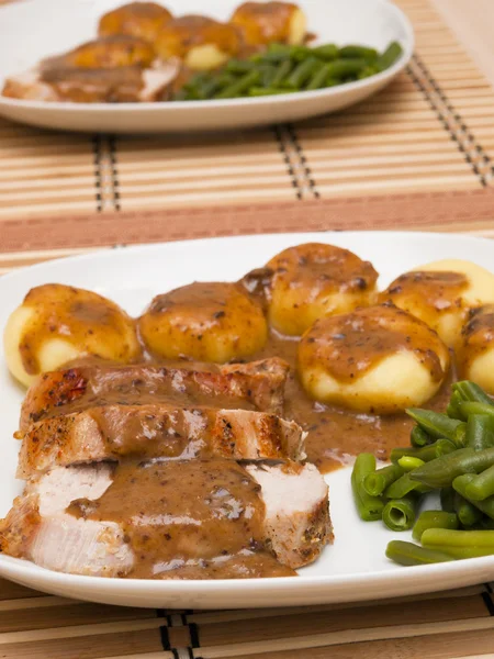 stock image Roast pork in gravy with silesian noodles