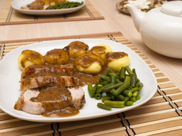 Roast pork in gravy with silesian noodles — Stock Photo, Image