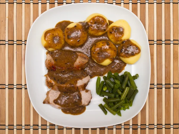 Roast pork in gravy with Silesian dumplings — Stock Photo, Image