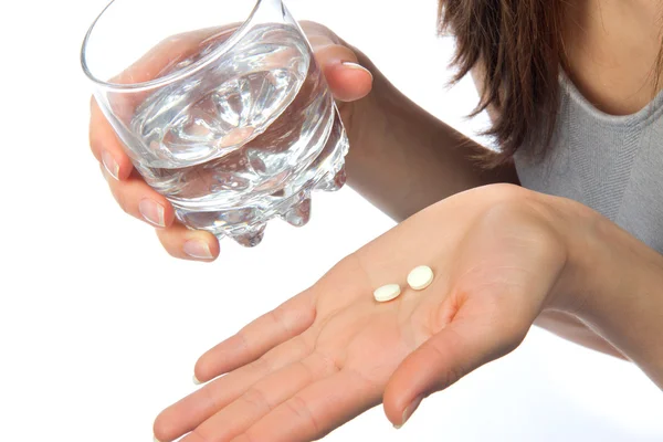 Headache hand with pills medicine tablets ang glass of water — Stock Photo, Image