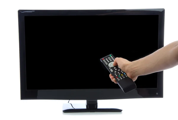 stock image Hand with remote control turning on led tv