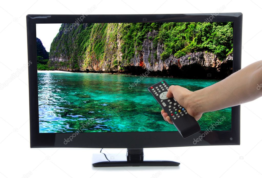 Hand with remote control turning on led tv