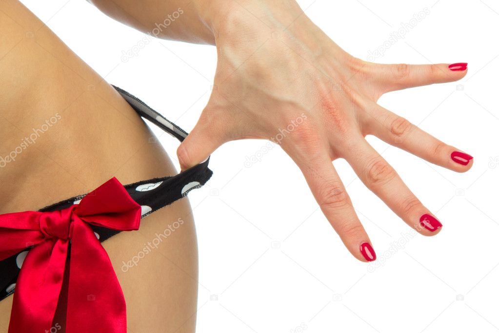 Sexy body of young beautiful caucasian woman taking off her sexy lingerie panties or thongs by hand with perfect manicure shellac on a white background