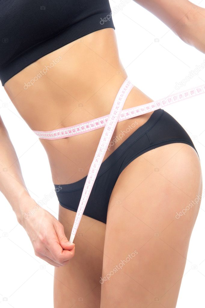 Woman measuring her waist metric tape measure