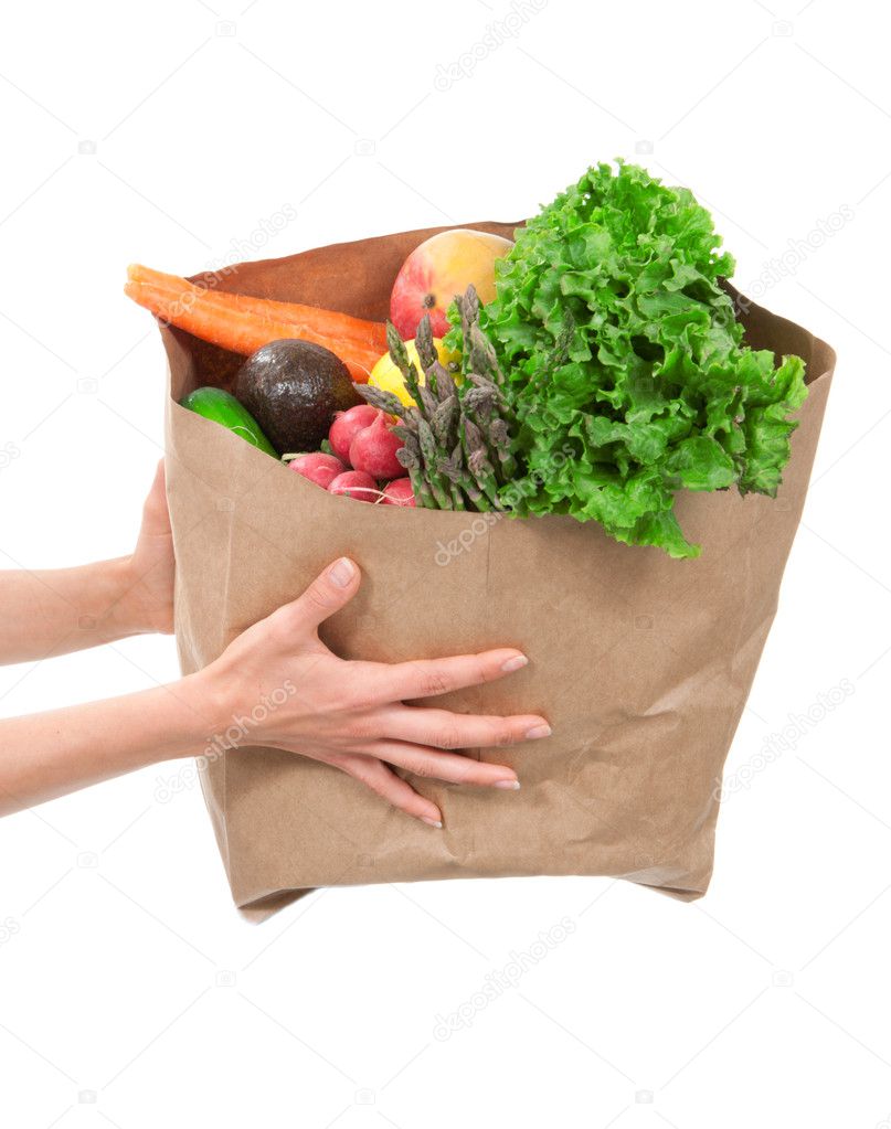 Hands holding a shopping bag full of groceries