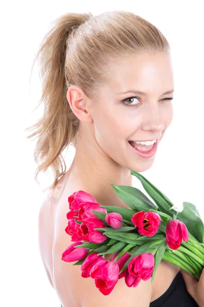 Beautiful woman with bouquet of red tulips flowers winks — Stock Photo, Image