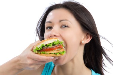 Young woman eating tasty fast food unhealthy burger clipart