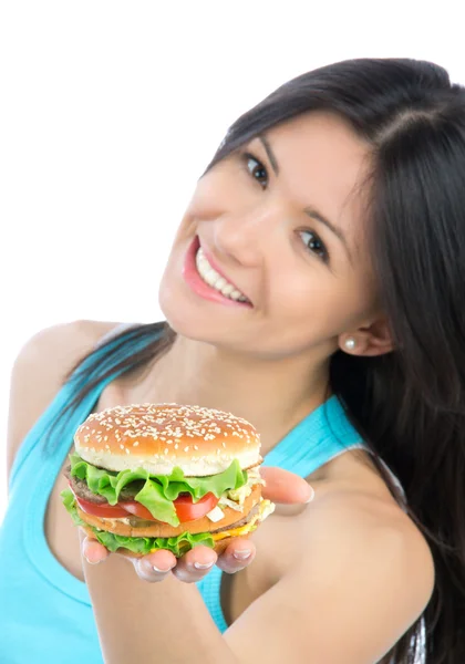 Woman with unhealthy burger in hand — Stock Photo, Image