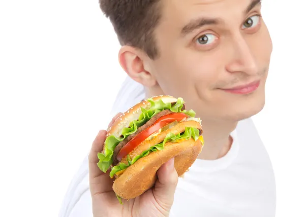 Young man with tasty fast food unhealthy burger — Stock Photo, Image