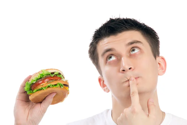 Joven con sabrosa comida rápida hamburguesa poco saludable — Foto de Stock