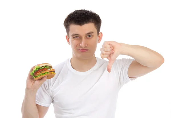 Fiatal férfi ízletes gyorséttermek egészségtelen burger — Stock Fotó