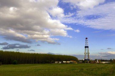 Oil rig, in the field. clipart