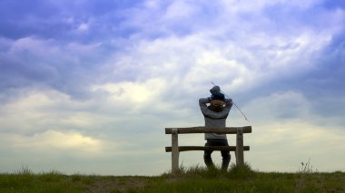 Father of his son sitting on the bench. clipart