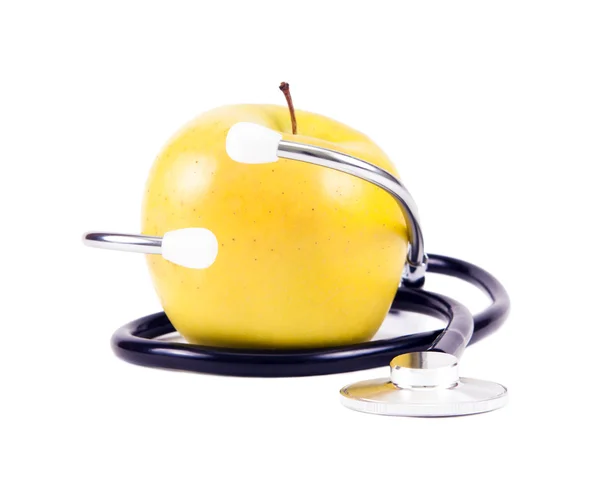 Estetoscopio médico y manzanas amarillas . — Foto de Stock