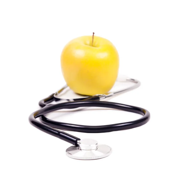 医用听诊器和黄色苹果. — 图库照片