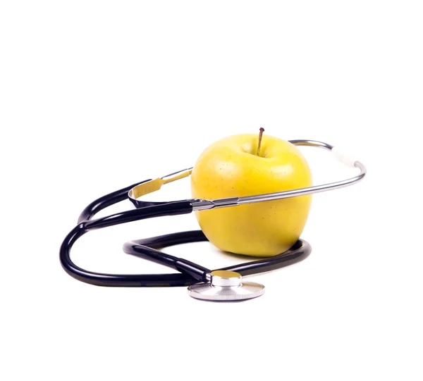 Geel, rijpe appel en stethoscoop. — Stockfoto