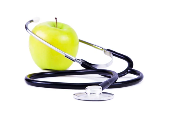 Green, ripe apple and stethoscope. — Stock Photo, Image