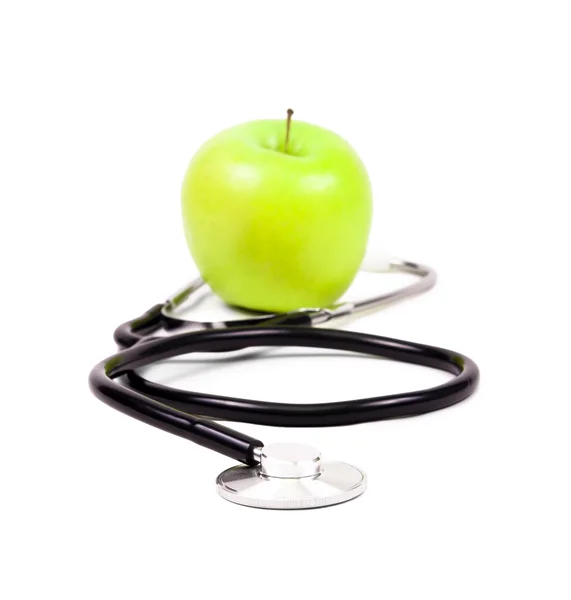 Estetoscopio médico y manzanas verdes . — Foto de Stock