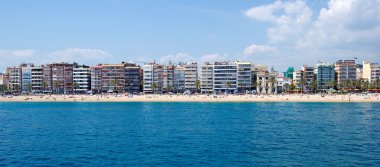 Panoramic cityscape of Lloret de Mar from sea, Costa Brava, Spai clipart