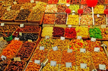 Abundance of nuts, fruits, sweet things at Barcelona market. clipart