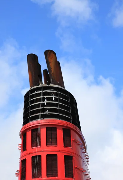 stock image Chimney of big cruise ship and blue sky in background.