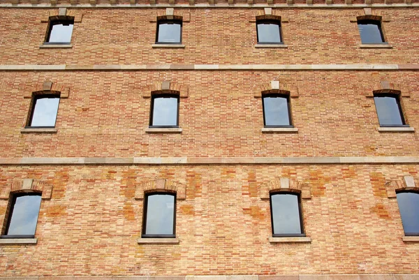 stock image Brick wall with windows as background or backdrop.