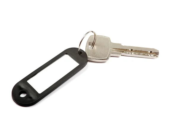 Ключ і чорна дрібничка з порожнім для вашого дизайнерського простору ізольовані — стокове фото