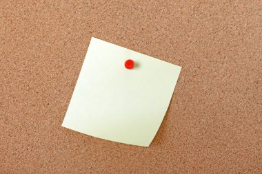 Yellow note paper attached with red pin to corkboard. Empty spac clipart