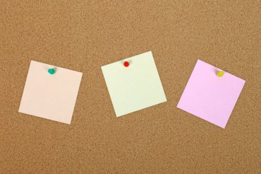 Three note papers attached to cork board with pins. clipart