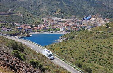 Camper on the road near spanish city Portbou, not far from borde clipart