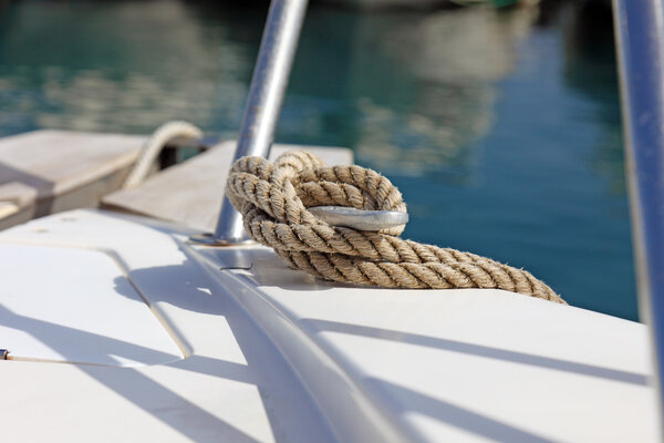 Boat rope on dock, fixing yacht.