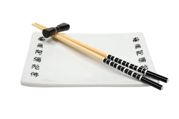 Stock image Unused asian chopsticks and plate isolated on white background.