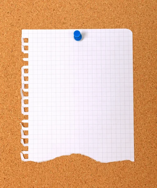 Torn note paper attached with blue pin to cork board, good as ba — Stock Photo, Image