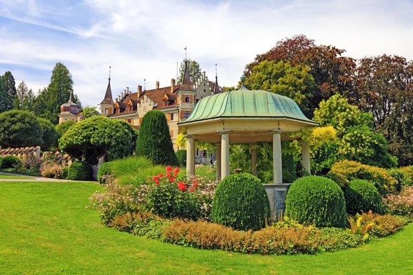 stock image Arbor and flowers near old castle, Switzerland.