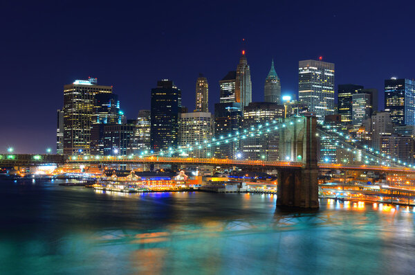 Brooklyn Bridge spans the East River towards Lower Manhattan in New York, New York.