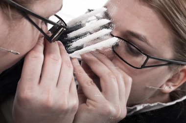 Drug addicted businesswoman snorting cocaine clipart