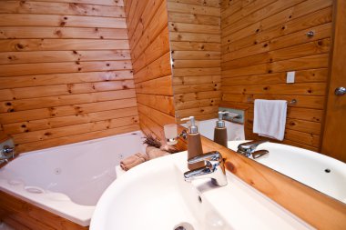 Wooden bathroom interior in mountain lodge clipart