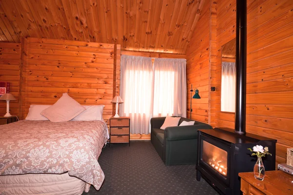 Lodge bedroom interior with fireplace — Stock Photo, Image