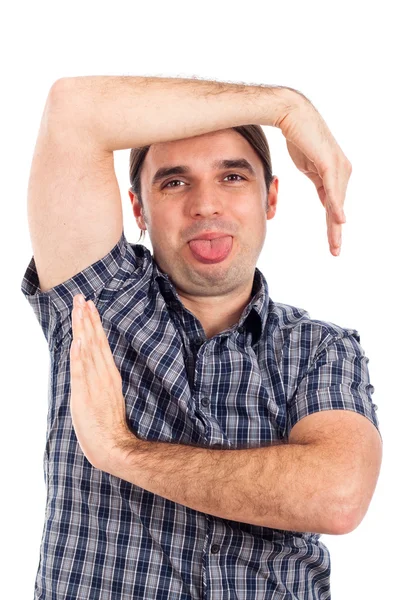 Homem fazendo caras engraçadas, gestos e salientando a língua — Fotografia de Stock