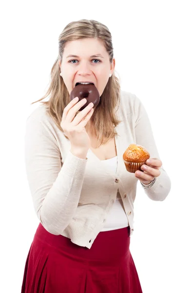 Woman eating chocolate donut and sweet muffin Stock Photo