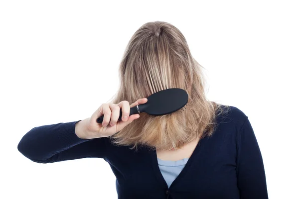 Woman covered her face using hairbrush — Stock Photo, Image