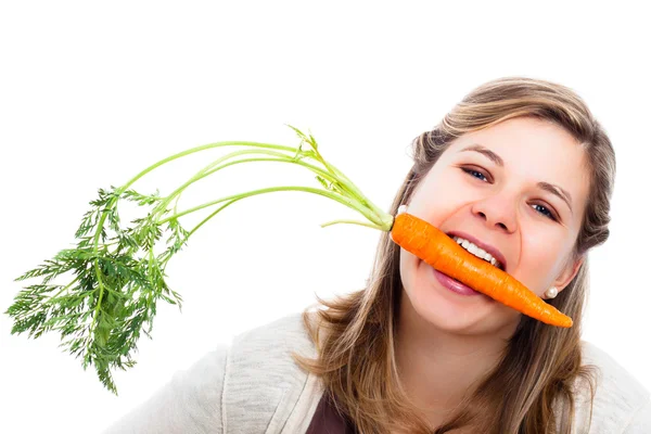 Funny woman eating fresh carrot — Stockfoto