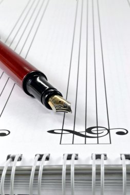 Blank sheet music with pen clipart