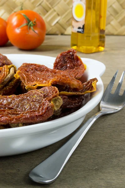 Dried tomatoes in white bowl — Stock Photo, Image