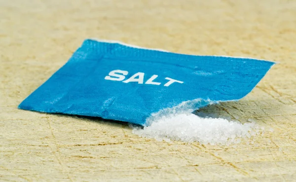 An open salt sachet — Stock Photo, Image